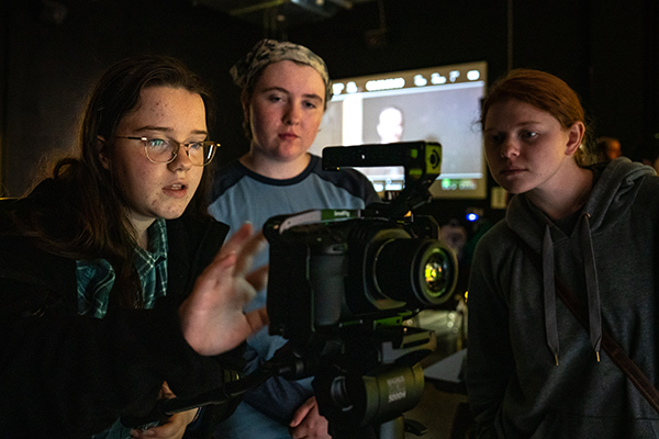 Students look at a video camera